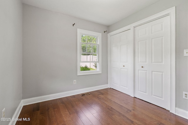 11 Thatcher Dr, Altamont, NY 12009 - unfurnished bedroom featuring dark wood-type flooring
