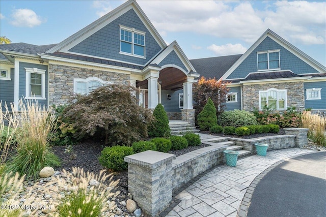 18 Rose Ter, Wilton, NY 12866 - view of front of home featuring stone siding, a standing seam roof, and covered porch