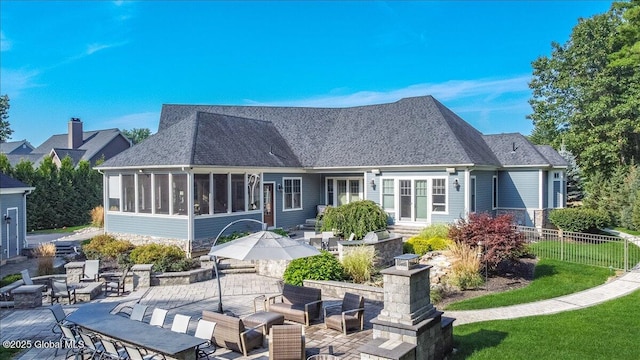 18 Rose Ter, Wilton, NY 12866 - rear view of property featuring a patio area, a sunroom, an outdoor living space, and a shingled roof