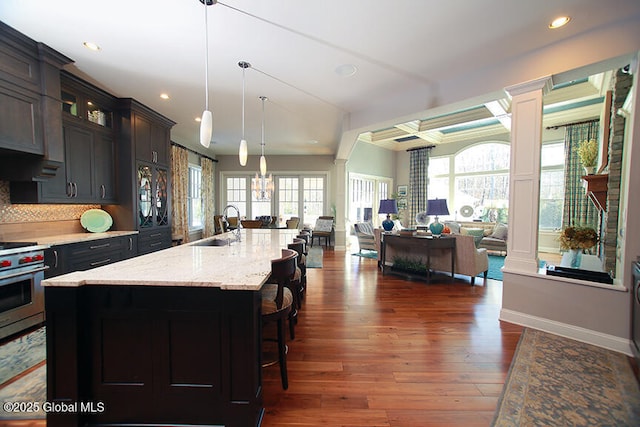 18 Rose Ter, Wilton, NY 12866 - kitchen featuring open floor plan, a sink, recessed lighting, glass insert cabinets, and stainless steel stove