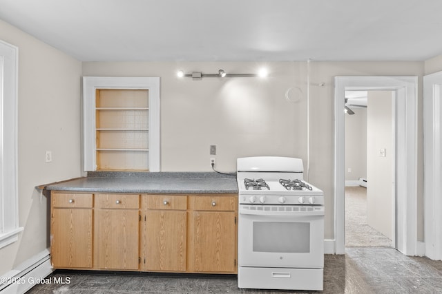 819 1st St, Rensselaer, NY 12144 - kitchen featuring gas range gas stove, a baseboard radiator, a baseboard heating unit, a ceiling fan, and dark countertops