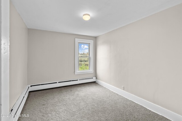 819 1st St, Rensselaer, NY 12144 - spare room featuring carpet floors, baseboard heating, and baseboards