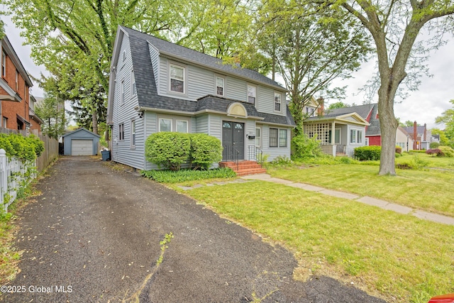 1013 Washington Ave, Albany, NY 12206 - colonial inspired home featuring driveway, an outbuilding, a front lawn, a garage, and a shingled roof