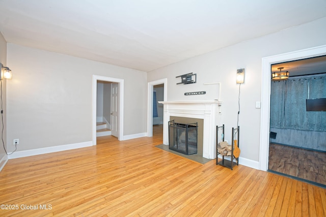 1013 Washington Ave, Albany, NY 12206 - unfurnished living room with light wood-style flooring, a fireplace with flush hearth, and baseboards