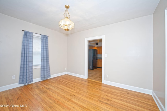 1013 Washington Ave, Albany, NY 12206 - unfurnished room with a chandelier, light wood-style floors, and baseboards