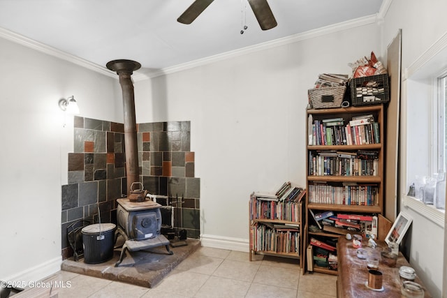 1022 State Route 29, Greenwich, NY 12834 - living area featuring a ceiling fan, crown molding, a wood stove, tile patterned flooring, and baseboards