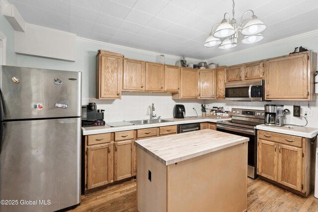 1022 State Route 29, Greenwich, NY 12834 - kitchen with appliances with stainless steel finishes, a sink, ornamental molding, butcher block counters, and a chandelier