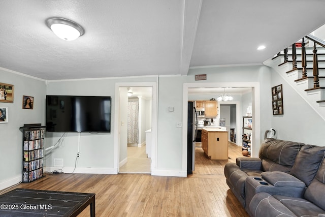 1022 State Route 29, Greenwich, NY 12834 - living area featuring stairs, light wood finished floors, baseboards, a chandelier, and crown molding