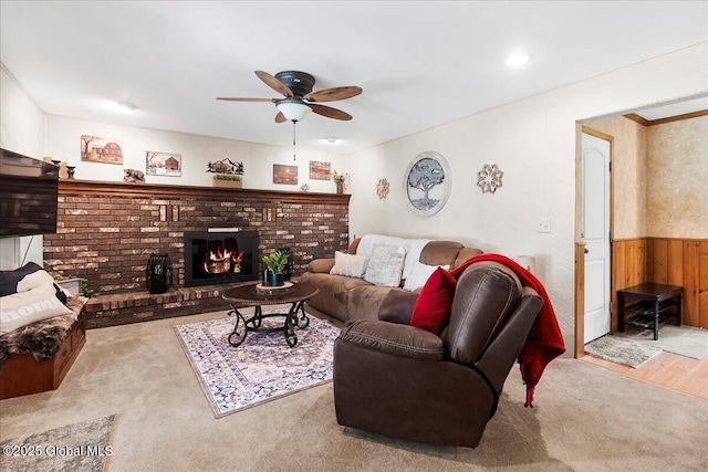 617 Cindy Ln, Ballston, NY 12020 - living room with ceiling fan, wainscoting, carpet floors, wood walls, and a fireplace