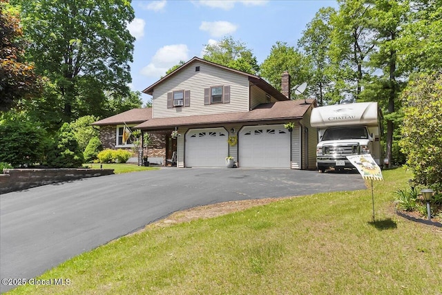 617 Cindy Ln, Ballston, NY 12020 - view of front of property featuring driveway, a front lawn, a chimney, and a garage