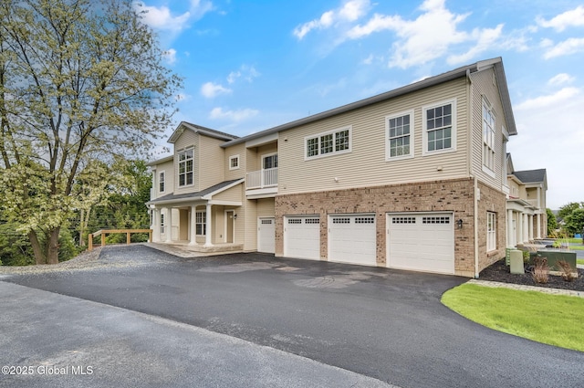 601 Vly Pointe Dr, Niskayuna, NY 12309 - view of front of property featuring driveway, an attached garage, brick siding, and a balcony
