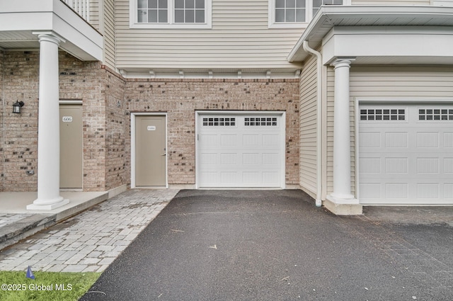 601 Vly Pointe Dr, Niskayuna, NY 12309 - property entrance featuring brick siding, driveway, and a garage