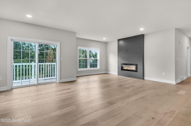 601 Vly Pointe Dr, Niskayuna, NY 12309 - unfurnished living room with light wood-style floors, a fireplace, baseboards, and recessed lighting