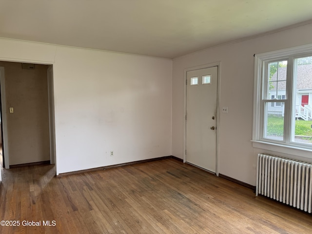 46 Elmhurst Ave, Albany, NY 12203 - entrance foyer with radiator heating unit, wood finished floors, crown molding, and baseboards
