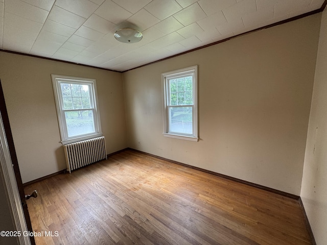 46 Elmhurst Ave, Albany, NY 12203 - spare room with radiator, crown molding, plenty of natural light, wood finished floors, and baseboards