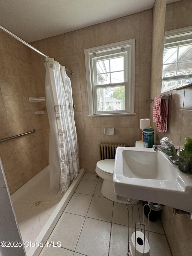 46 Elmhurst Ave, Albany, NY 12203 - full bathroom featuring tile walls, radiator heating unit, a stall shower, toilet, and tile patterned flooring