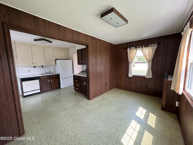 46 Elmhurst Ave, Albany, NY 12203 - kitchen with white appliances, wood walls, light countertops, a sink, and dark brown cabinetry