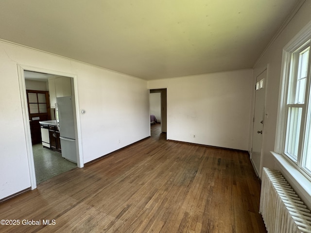 46 Elmhurst Ave, Albany, NY 12203 - unfurnished room featuring radiator heating unit, dark wood-style floors, and baseboards
