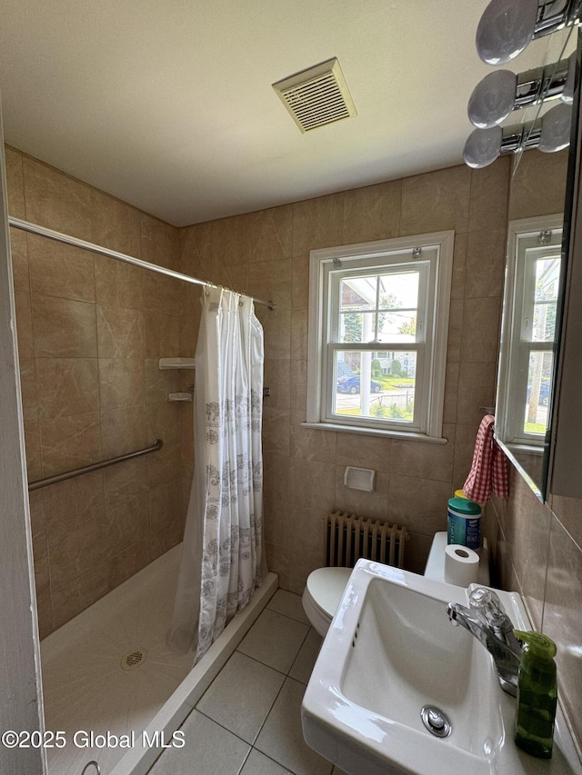 46 Elmhurst Ave, Albany, NY 12203 - full bath featuring radiator, tile walls, tile patterned flooring, a sink, and a shower stall