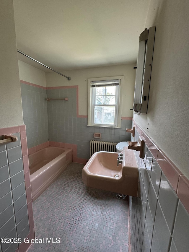 46 Elmhurst Ave, Albany, NY 12203 - full bathroom featuring tile walls, radiator heating unit, bathtub / shower combination, and wainscoting
