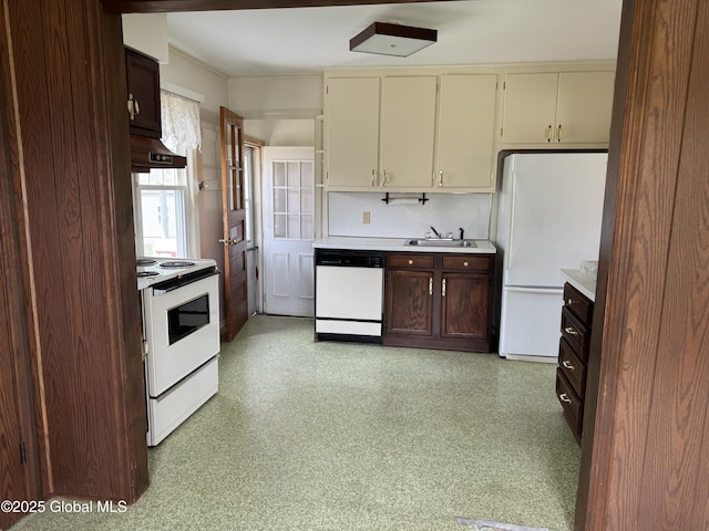 46 Elmhurst Ave, Albany, NY 12203 - kitchen with white appliances, light countertops, wall chimney range hood, cream cabinetry, and light flooring