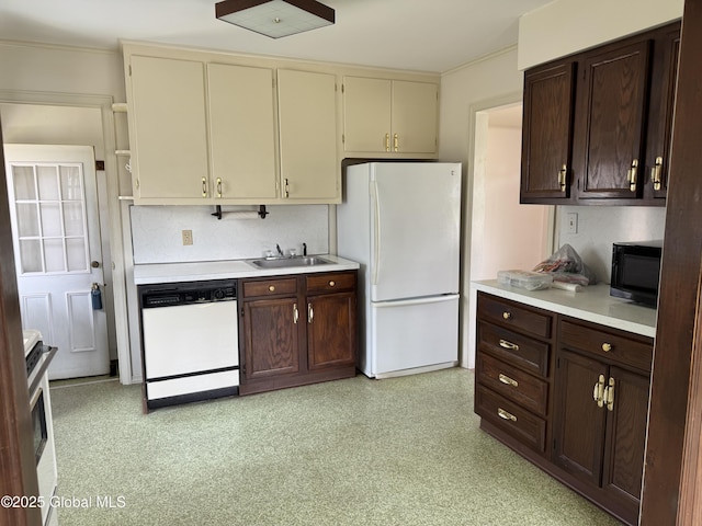 46 Elmhurst Ave, Albany, NY 12203 - kitchen with white appliances, a sink, light countertops, dark brown cabinetry, and crown molding