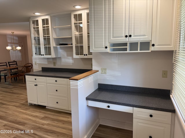 12 Graves St, Glens Falls, NY 12801 - kitchen featuring open shelves, wood finished floors, a chandelier, white cabinetry, and glass insert cabinets