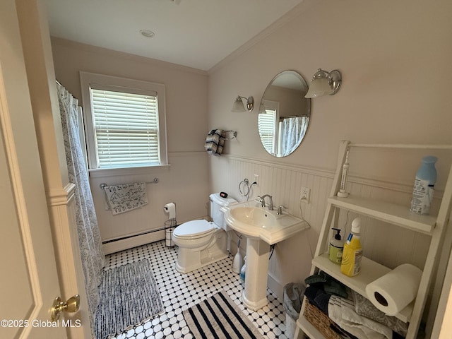 12 Graves St, Glens Falls, NY 12801 - full bathroom with baseboard heating, toilet, a wainscoted wall, tile patterned floors, and curtained shower