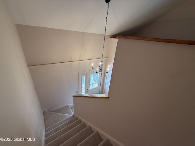12 Graves St, Glens Falls, NY 12801 - staircase featuring a chandelier, carpet flooring, lofted ceiling, and baseboards