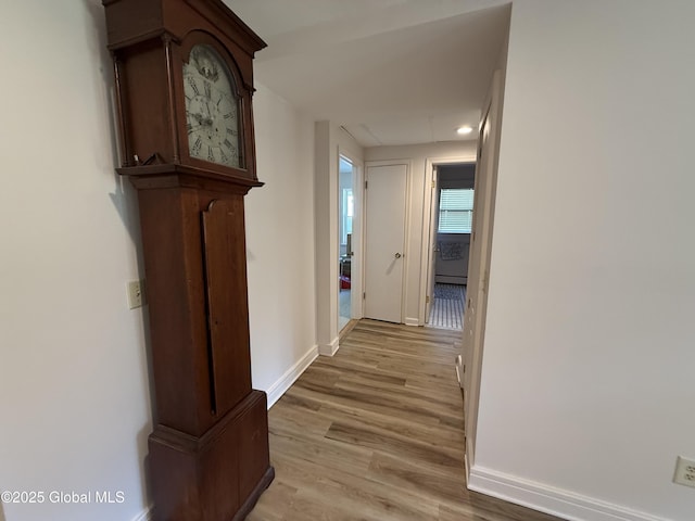 12 Graves St, Glens Falls, NY 12801 - hallway featuring baseboards, light wood finished floors, and a baseboard heating unit