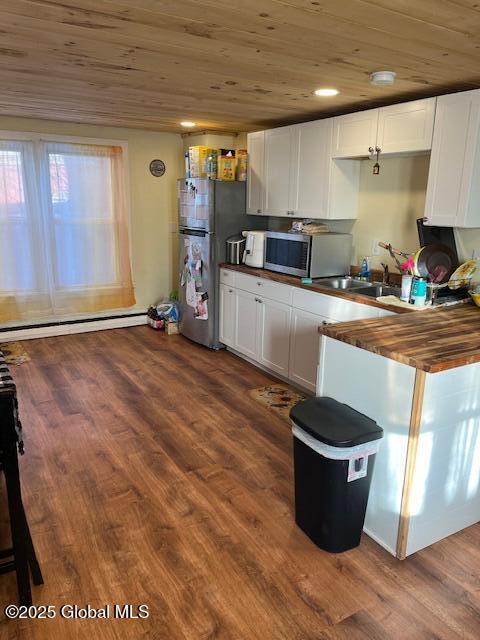 159 Champlain Ave, Ticonderoga, NY 12883 - kitchen featuring stainless steel appliances, wood ceiling, butcher block countertops, white cabinetry, and dark wood finished floors