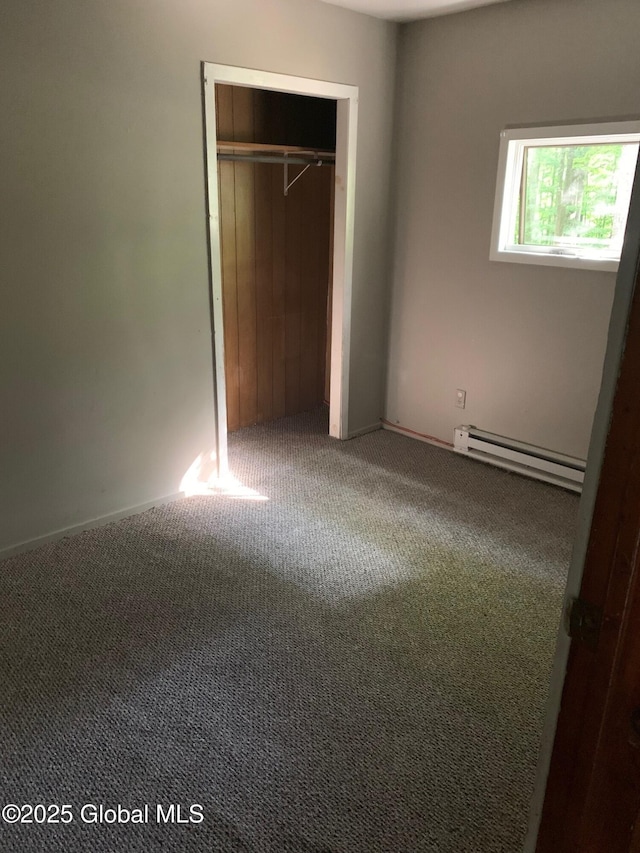 326 Middle Rd, Crown Point, NY 12928 - unfurnished bedroom featuring a baseboard heating unit, carpet flooring, and a closet