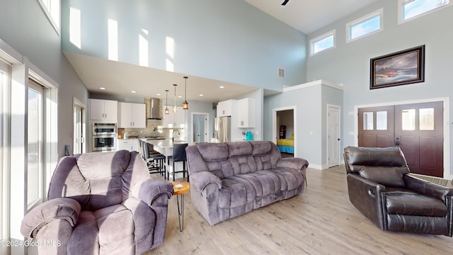 74 Dick Hyatt Ln, Whitehall, NY 12887 - living area with a high ceiling, light wood-type flooring, and baseboards