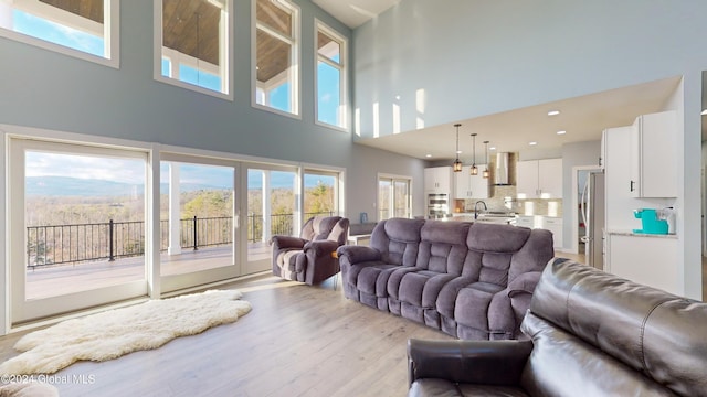 74 Dick Hyatt Ln, Whitehall, NY 12887 - living room featuring a towering ceiling, light wood-style floors, and recessed lighting