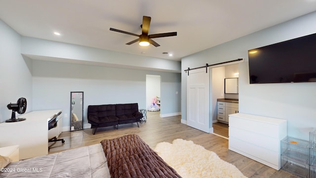 74 Dick Hyatt Ln, Whitehall, NY 12887 - bedroom with a barn door, light wood-style flooring, recessed lighting, connected bathroom, and ceiling fan