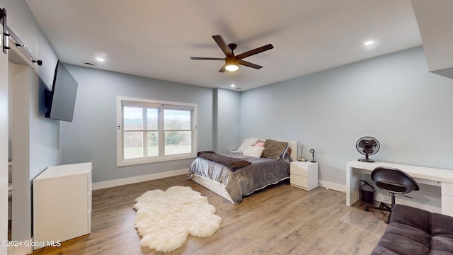 74 Dick Hyatt Ln, Whitehall, NY 12887 - bedroom featuring a barn door, light wood-style flooring, baseboards, a ceiling fan, and recessed lighting