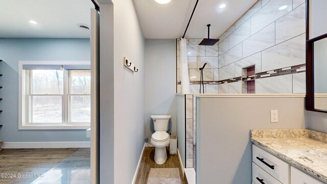 74 Dick Hyatt Ln, Whitehall, NY 12887 - bathroom featuring vanity, wood finished floors, walk in shower, recessed lighting, and toilet