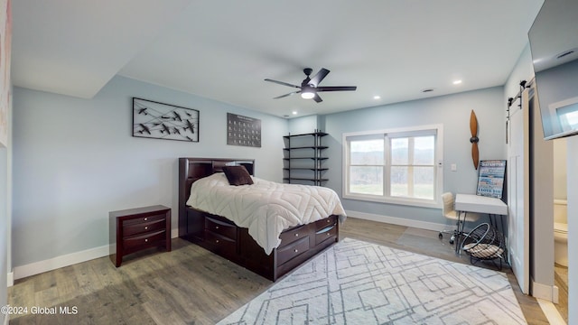 74 Dick Hyatt Ln, Whitehall, NY 12887 - bedroom featuring a barn door, multiple windows, wood finished floors, baseboards, and recessed lighting