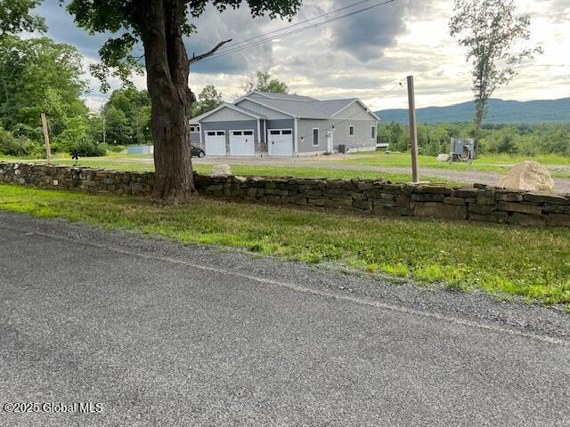 74 Dick Hyatt Ln, Whitehall, NY 12887 - view of front facade featuring a garage and a mountain view