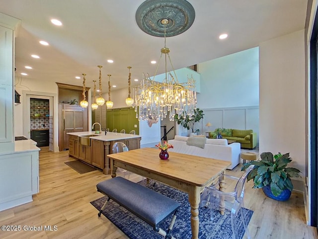 22 Burnham Rd, Wilton, NY 12831 - dining space featuring a decorative wall, light wood-type flooring, wainscoting, recessed lighting, and a chandelier