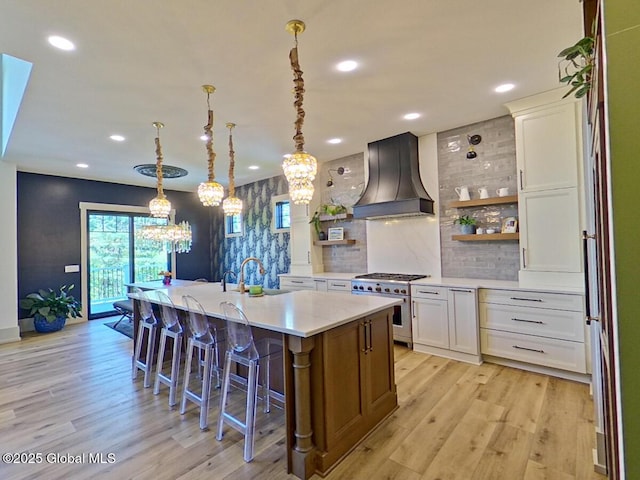 22 Burnham Rd, Wilton, NY 12831 - kitchen with high end range, custom range hood, open shelves, a chandelier, and light wood finished floors