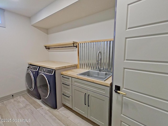 22 Burnham Rd, Wilton, NY 12831 - laundry room with washing machine and dryer, light wood-type flooring, baseboards, and cabinet space