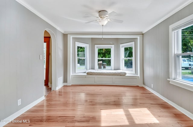 44 Hudson Ave, Bethlehem, NY 12054 - unfurnished room with ornamental molding, arched walkways, ceiling fan, healthy amount of natural light, and light wood-style floors