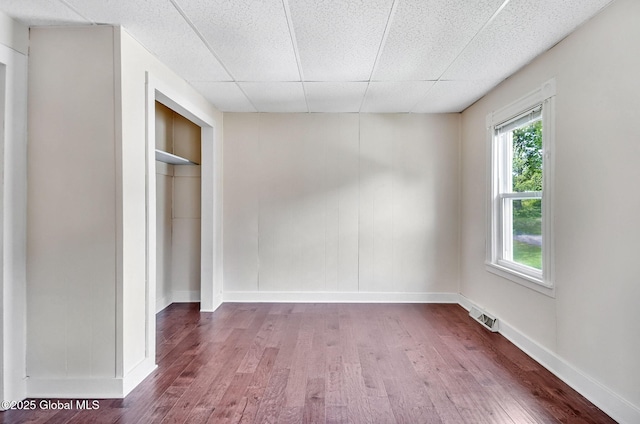44 Hudson Ave, Bethlehem, NY 12054 - unfurnished bedroom with wood finished floors, baseboards, a paneled ceiling, and a closet