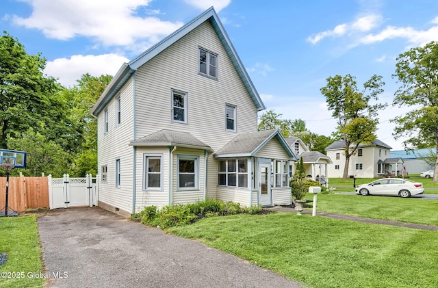 44 Hudson Ave, Bethlehem, NY 12054 - view of front facade featuring a sunroom, a gate, and driveway