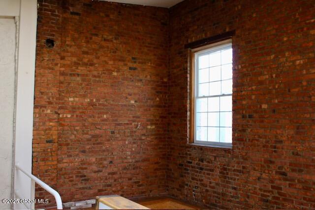 7 Garden Aly, Albany, NY 12210 - unfurnished room featuring brick wall