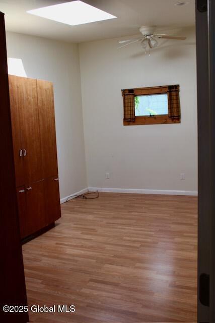 7 Garden Aly, Albany, NY 12210 - spare room featuring light wood-style floors, a ceiling fan, and baseboards