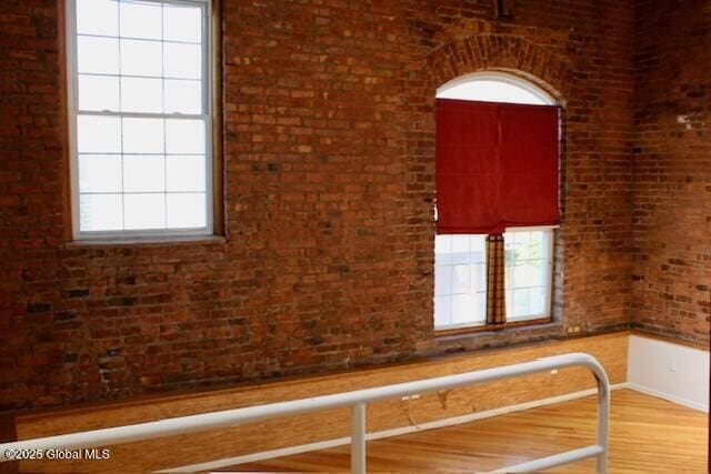 7 Garden Aly, Albany, NY 12210 - spare room featuring wood finished floors and brick wall