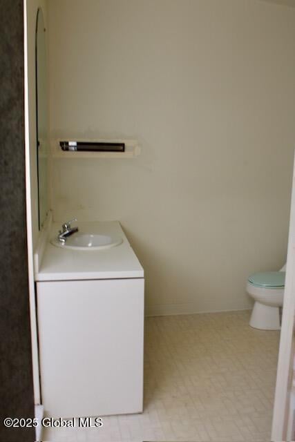 7 Garden Aly, Albany, NY 12210 - bathroom with toilet, vanity, and tile patterned floors