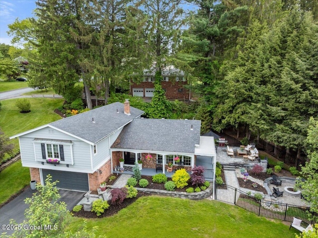 1335 Stanley Ln, Niskayuna, NY 12309 - rear view of property with brick siding, roof with shingles, a gate, a chimney, and an attached garage